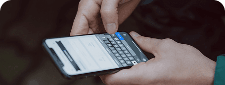 A person typing and sharing a review on a mobile phone keyboard